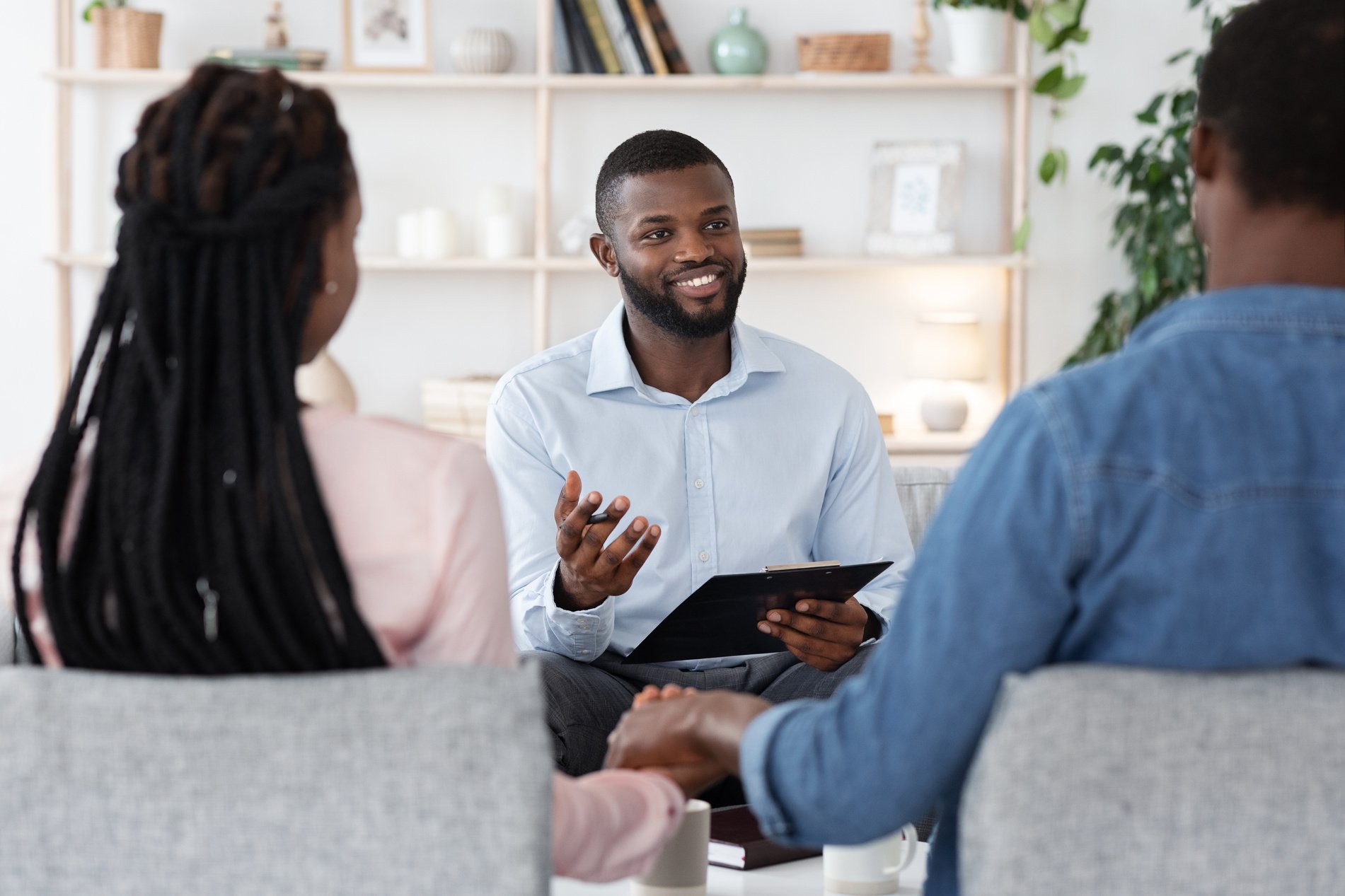 Couples Therapy Session. Counselor Talking To Black Husband And Wife At Office